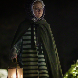 1830s dressed women walking at night carrying lantern,