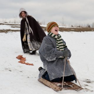 Kids in costume sledding