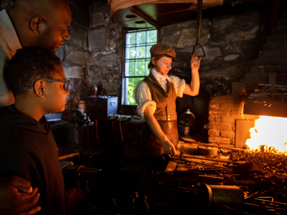 A father and son visit the Blacksmith Shop