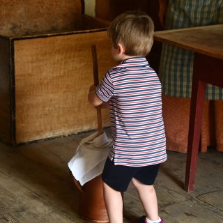 A young child churns butter